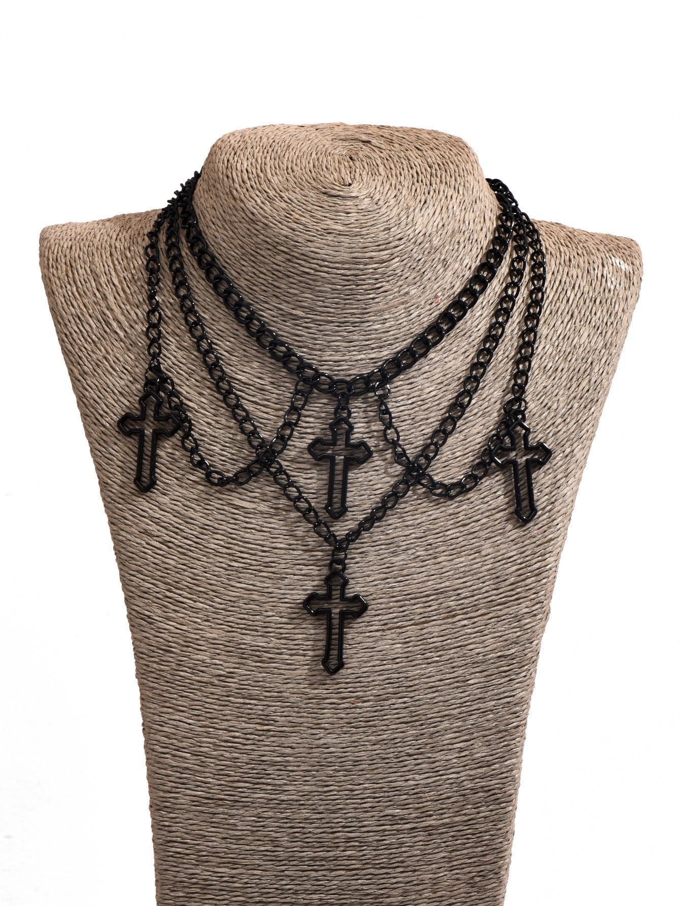 Multilayered cross necklace by eprolo featuring multiple gold-tone chains and a prominent cross pendant.