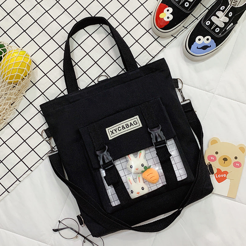 Transparent canvas shoulder bag with printed design, featuring a spacious main compartment and adjustable shoulder strap.