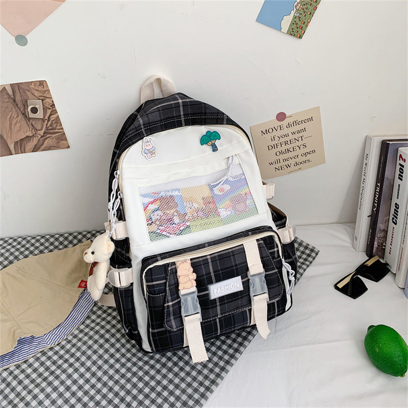 Eprolo Kareli Japon tarzı sırt çantası with black and white checkered pattern, front zipper pocket, and adjustable shoulder straps.
