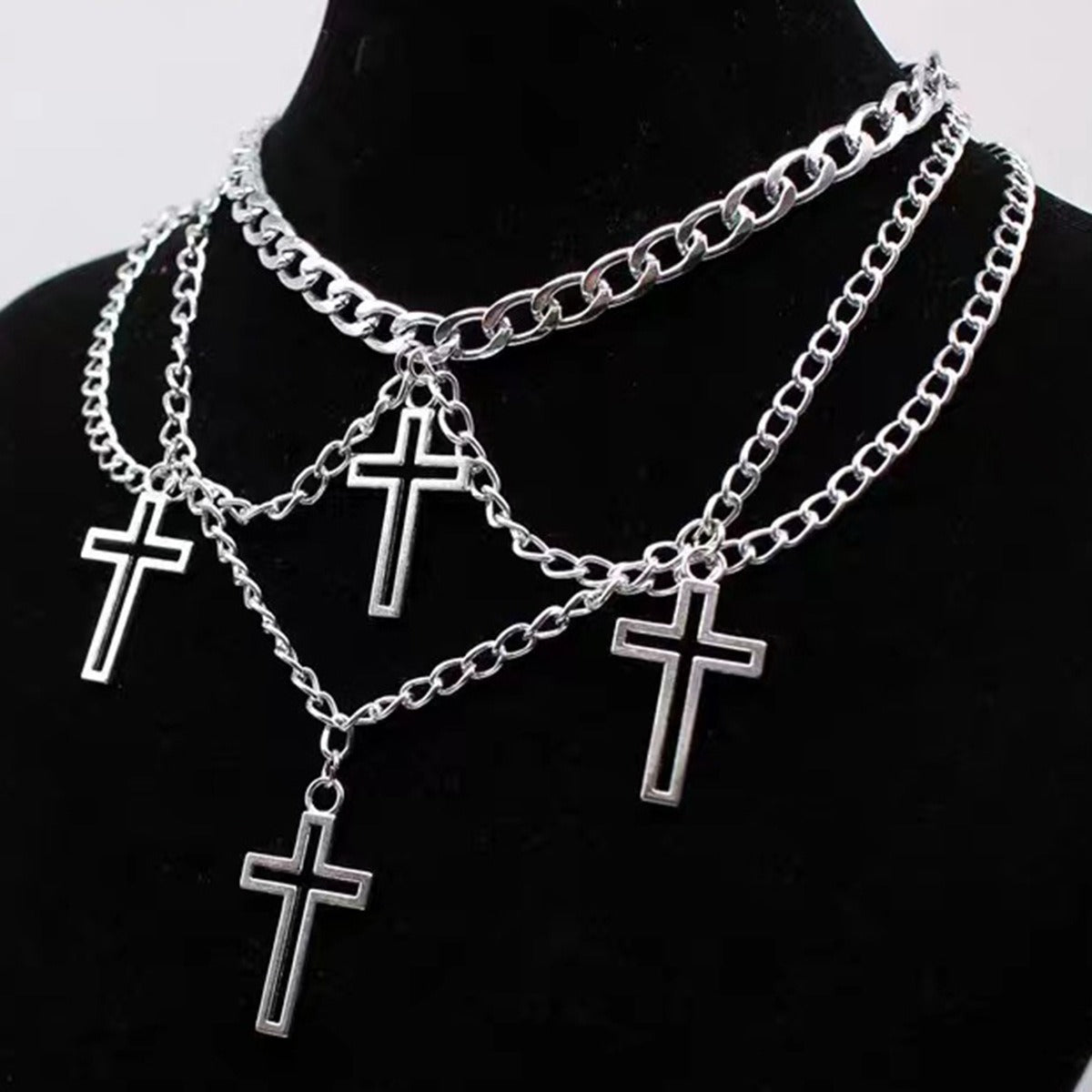 Multi-layered cross necklace from eprolo featuring overlapping metal crosses on a chain, stylish and modern jewelry accessory.
