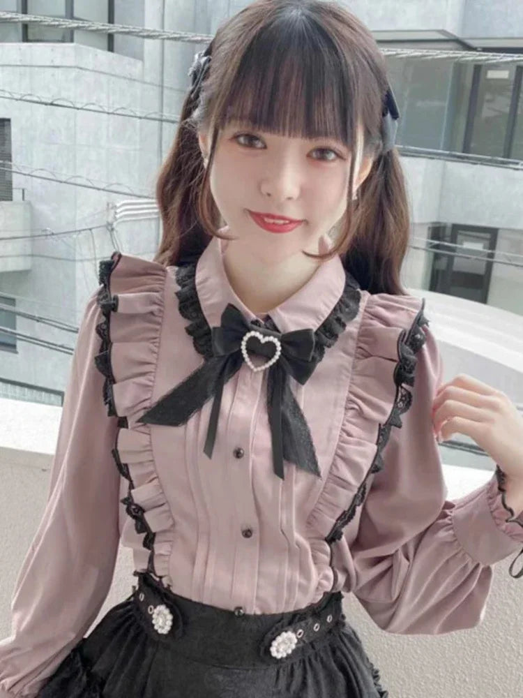 Pink ruffled lace blouse with bow detail by eprolo, featuring delicate lace and fluttery fabric for a feminine look.